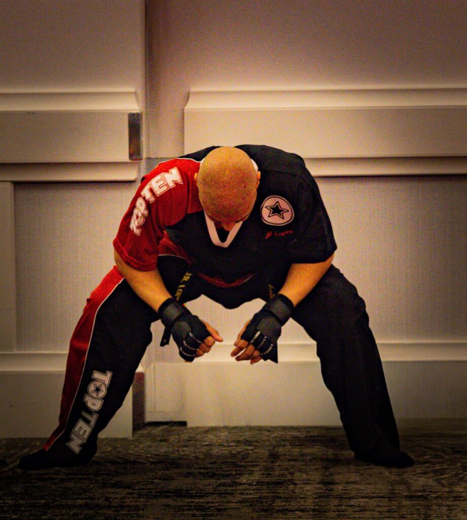 JR Lopez in competition uniform, head bowed in focus before a match